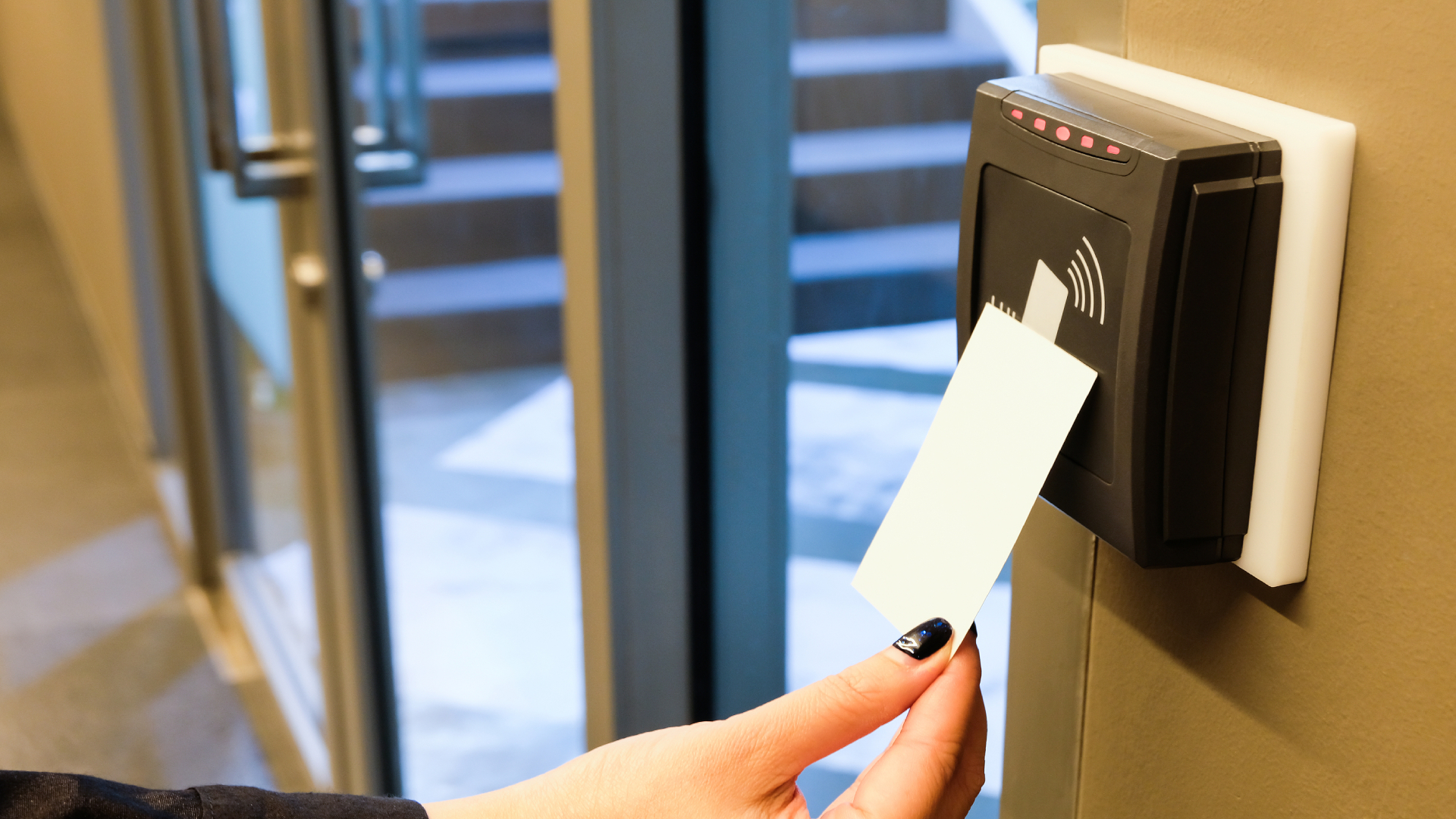 Employee tapping an RFID access card on a door reader to enter a secure office in Pakistan