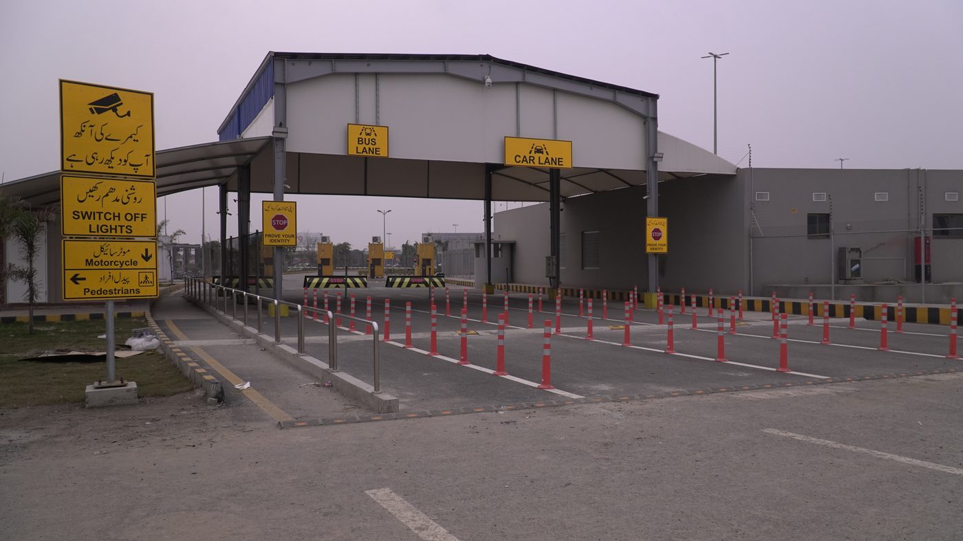 Vehicle checkpoint with car lane and bus lane traffic barriers at Allama Iqbal International Airport, Lahore