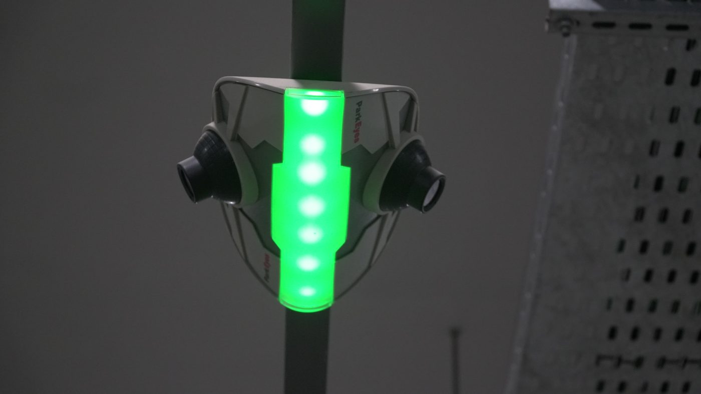 ParkEyes parking guidance sensor with green availability indicator at Allama Iqbal International Airport