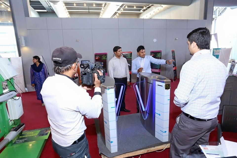 ASG Systems team demonstrating a flap barrier speed gate to media at a security exhibition