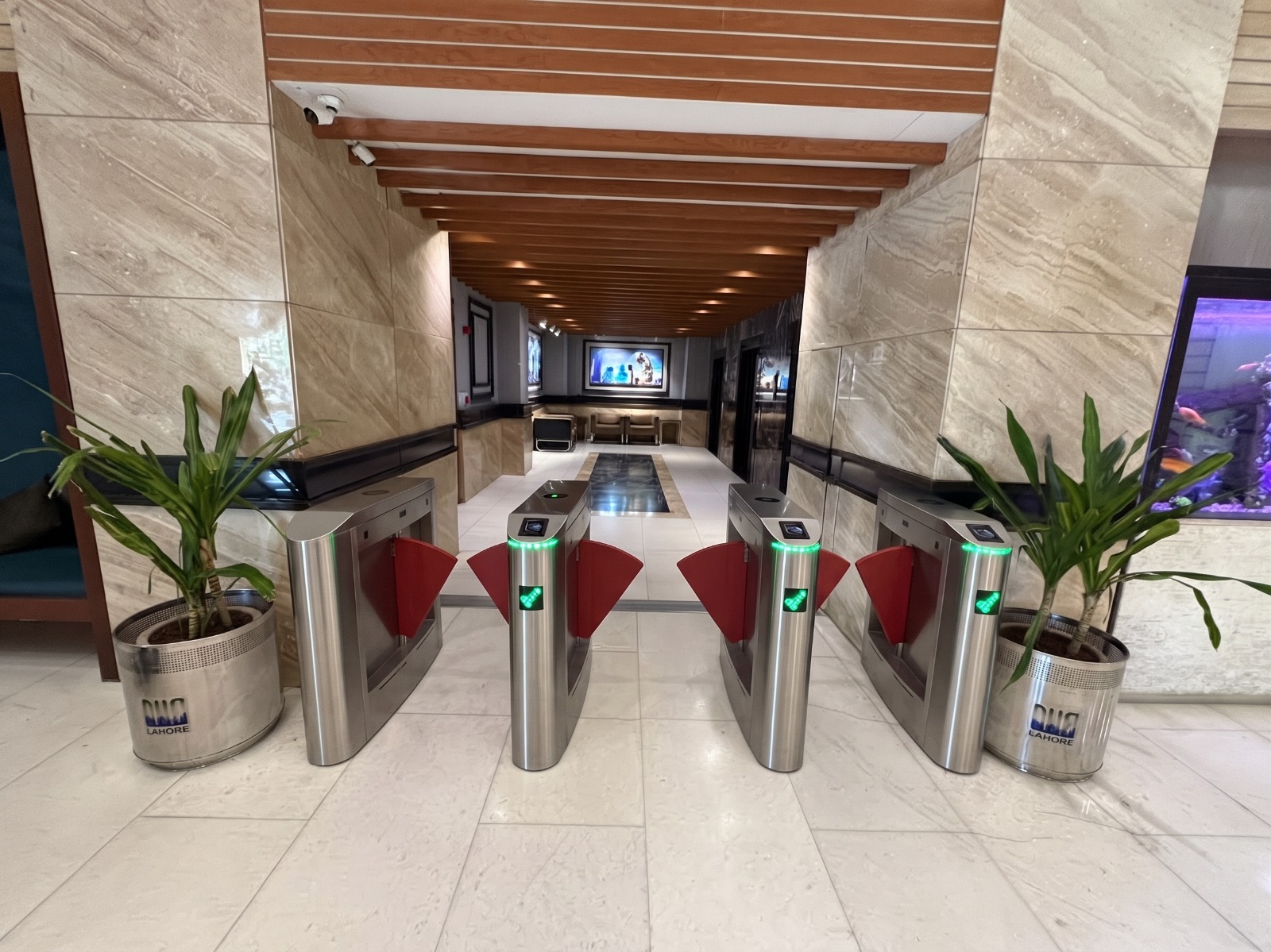 Row of flap barrier speed gates in a modern office lobby