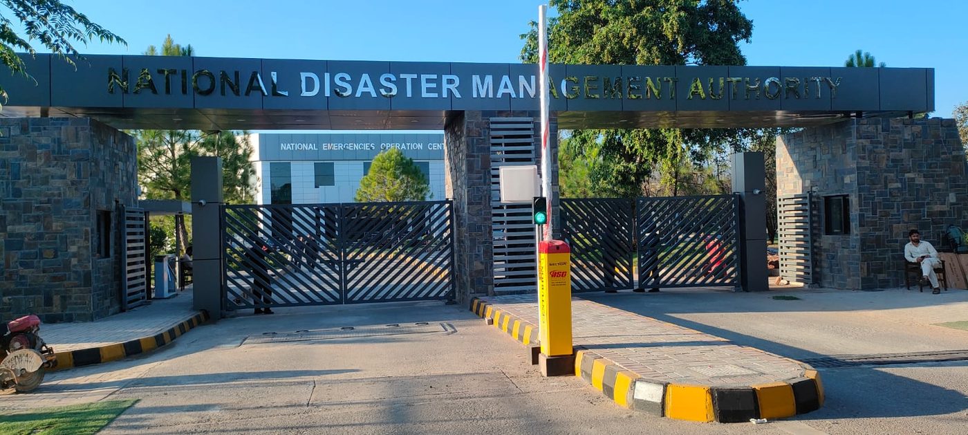 NDMA Headquarters main gate with Centurion boom barrier raised and green signal light, Islamabad