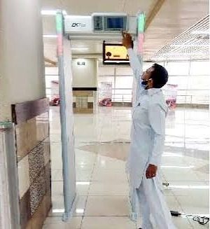Security staff conducting passenger screening at an Orange Line Metro checkpoint
