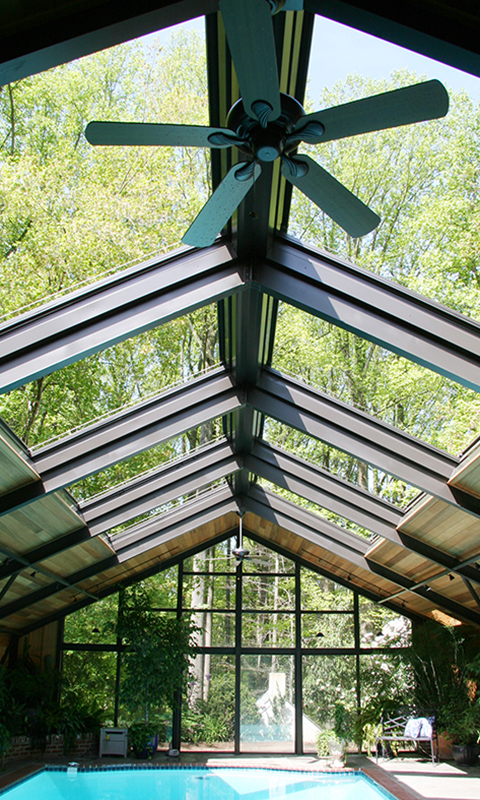 Glazed pitched skylight roof over an indoor swimming pool filling the space with daylight