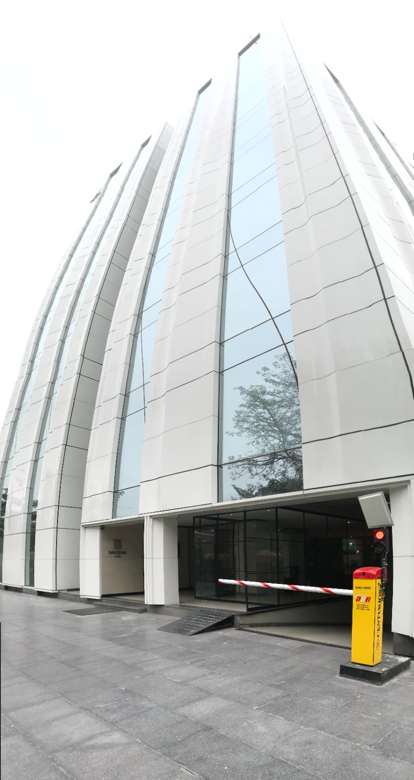 Automatic boom barrier at the basement car park entrance of a modern commercial building