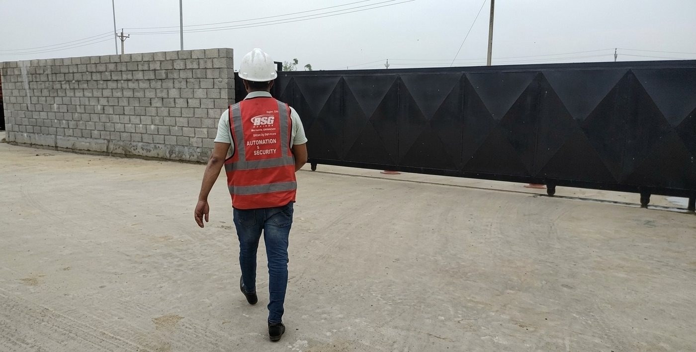 ASG Systems technician inspecting an automated perimeter gate at a CCBPL plant