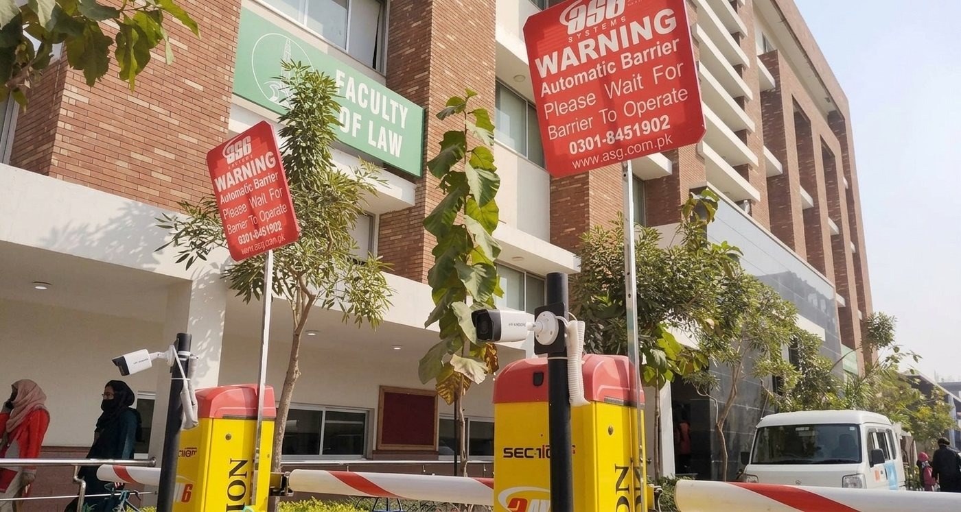 Automatic barrier checkpoint outside the Faculty of Law building at the University of Lahore