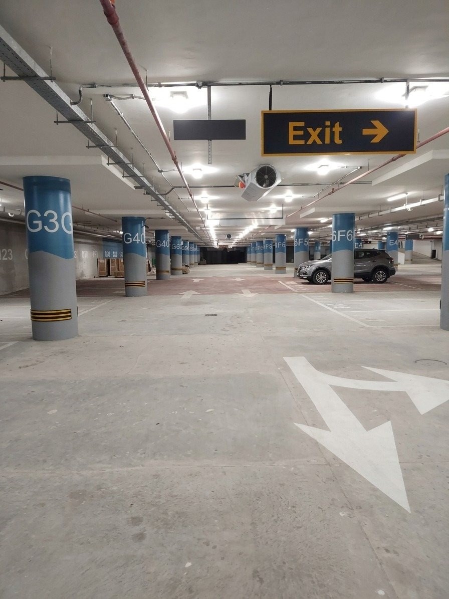 Interior view of the Raya Fairways parking structure with zone signage and exit wayfinding
