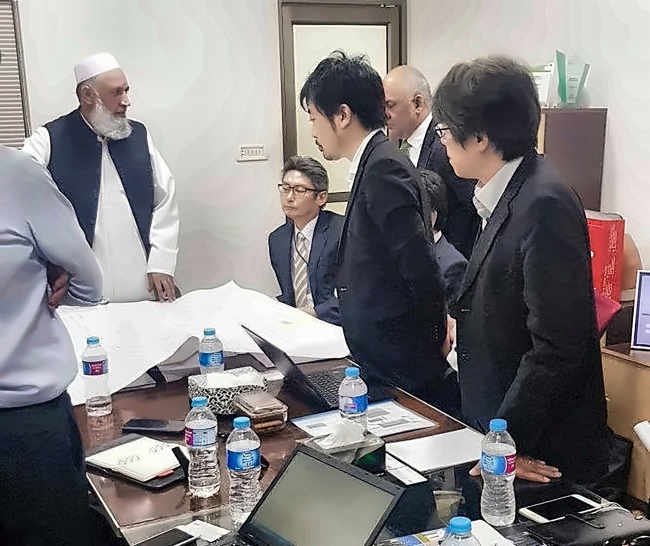ASG Systems leadership reviewing project layout drawings with the visiting JICA Japan team