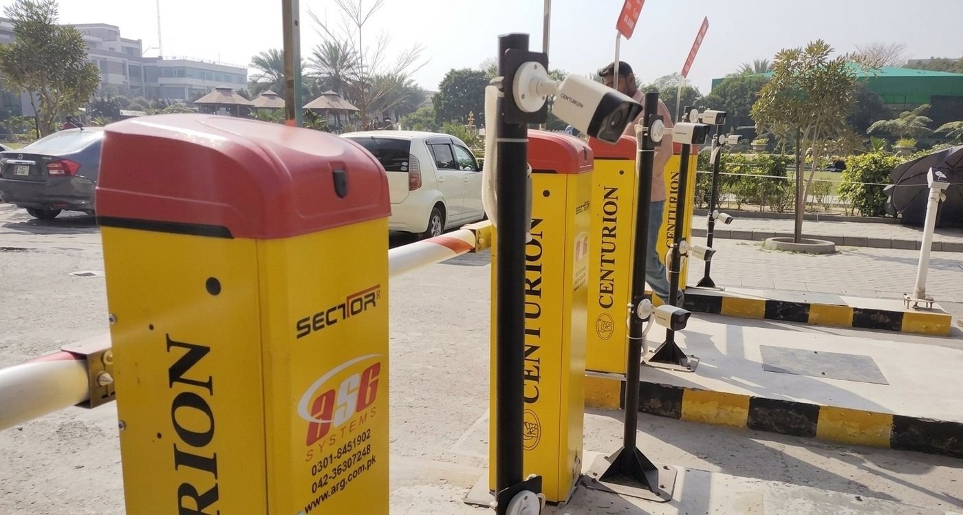 Multiple Centurion automatic boom barriers with CCTV cameras at a multi-lane campus checkpoint, University of Lahore