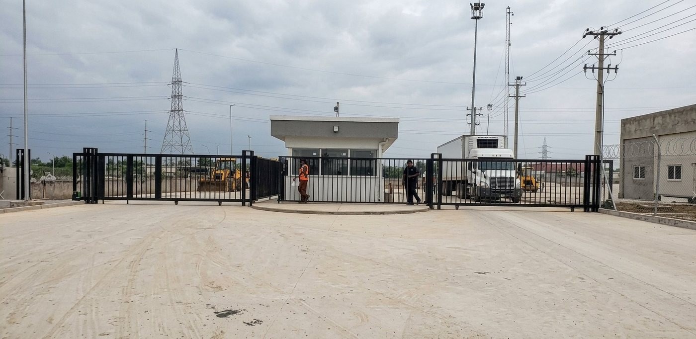 Vehicle access checkpoint with automated gate and guard booth at a CCBPL plant